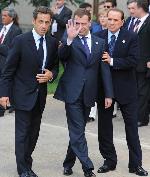 (L to R) French President Nicolas Sarkozy, Russian President Dmitri Medvedev, and Italian Prime Minister Silvio Berlusconi arrive to pose for a family photo at the Group of Eight (G8) summit in L'Aquila, central Italy, on July 8, 2009. Group of Eight leaders kick off talks today on issues ranging from the global financial crisis to climate change to the situations in Iran and Xinjiang, China. AFP PHOTO DDP/ POOL/ PEER GRIMM GERMANY OUT (Photo credit should read PEER GRIMM/AFP/Getty Images)
