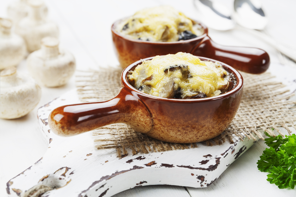 Mushrooms baked with cheese crust in cocotte