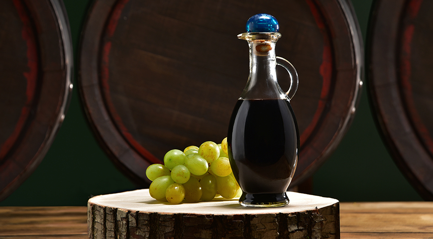 Balsamic vinegar with barrels in the background