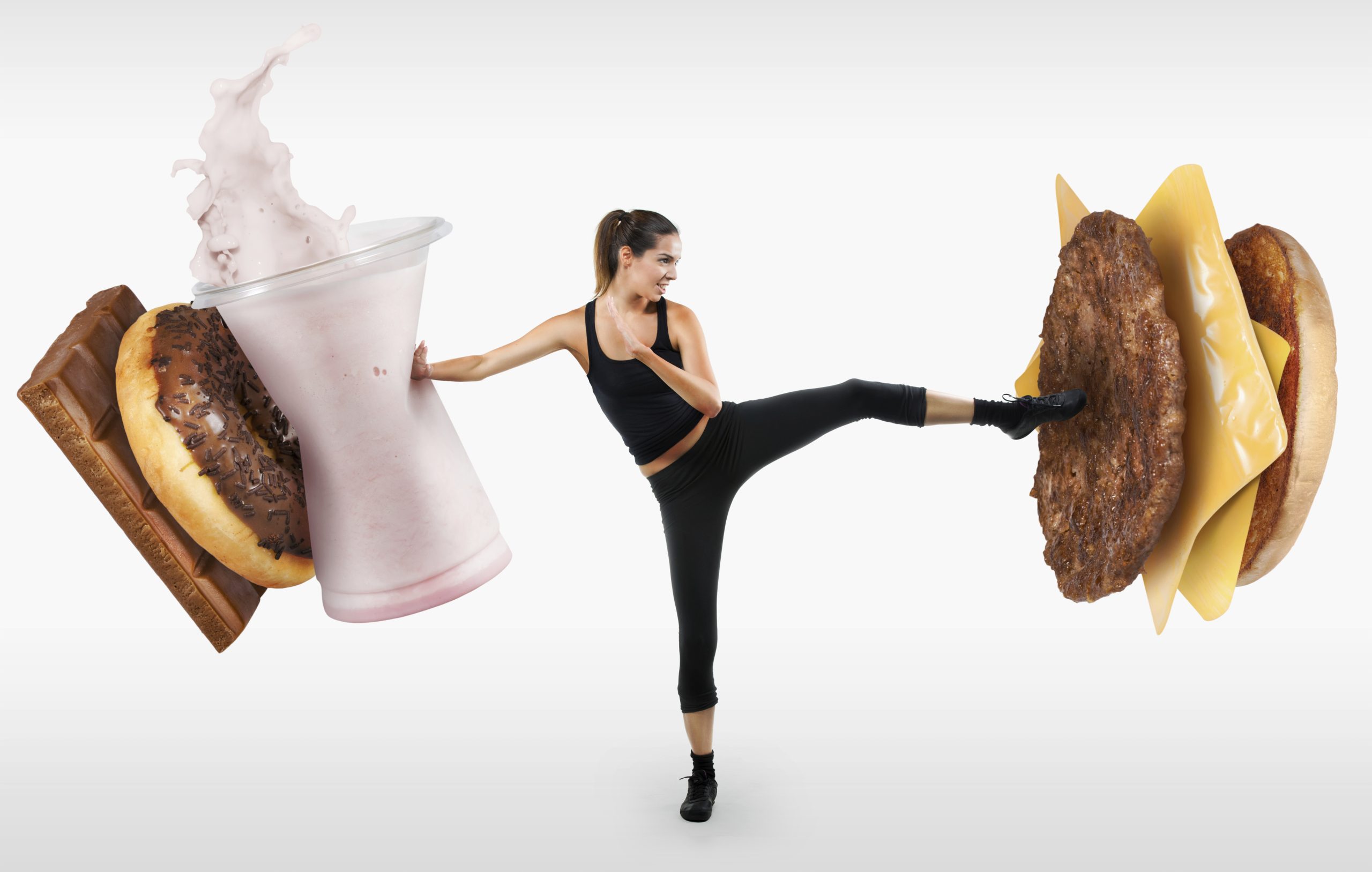 Fit young woman fighting off fast food